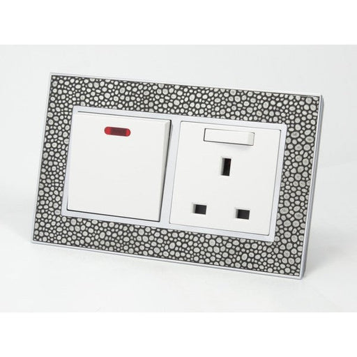 pearl leather double frame with white insert of switch and switched UK socket