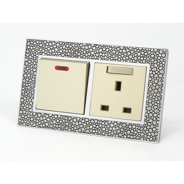 pearl leather double frame with gold insert of double switch and switched UK socket