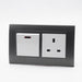 Dark Grey plastic with arc double frame with white inserts of 20a switch and uk socket