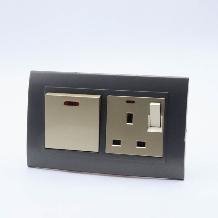 Dark Grey plastic with arc double frame with gold inserts of 45a switch and switched neon uk socket