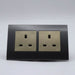 Dark Grey Plastic Arc Double Frame with gold Interests of both UK sockets